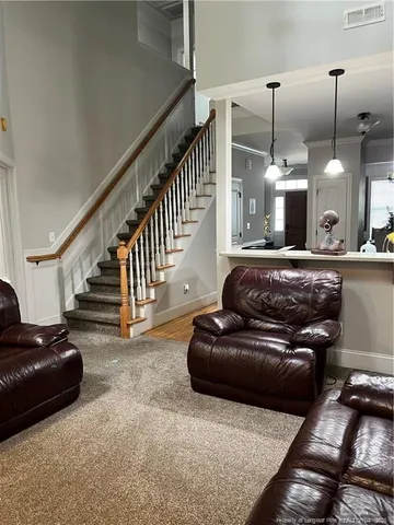 a living room with furniture and a chandelier