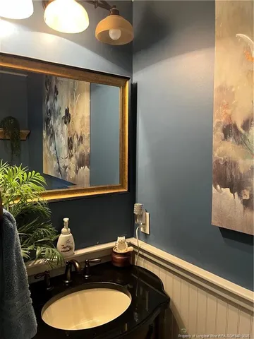 a bathroom with a sink mirror and vanity