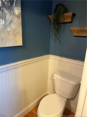 a white toilet sitting next to a shower