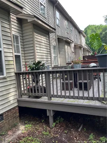 a backyard of a house with glass door and outdoor seating