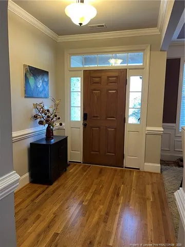 a room with wooden floor and furniture