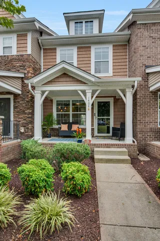 front view of a brick house with a yard