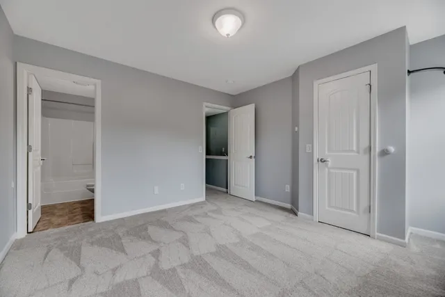 a view of an empty room and closet area