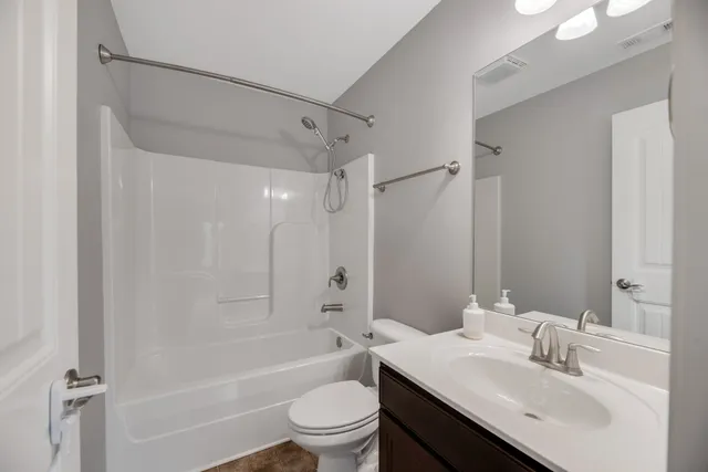 a bathroom with a sink toilet tub and shower