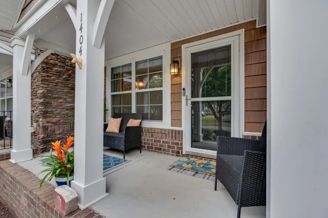 a balcony with furniture and a potted plant
