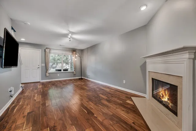 a view of an empty room with a fireplace and a window