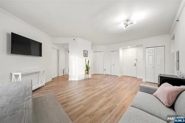 a spacious bedroom with a bed and a flat screen tv