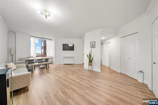 a view of empty room with furniture and window