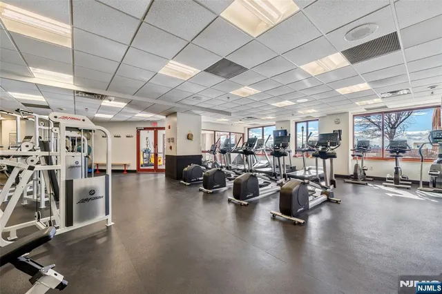 a gym room with lots of furniture and a gym