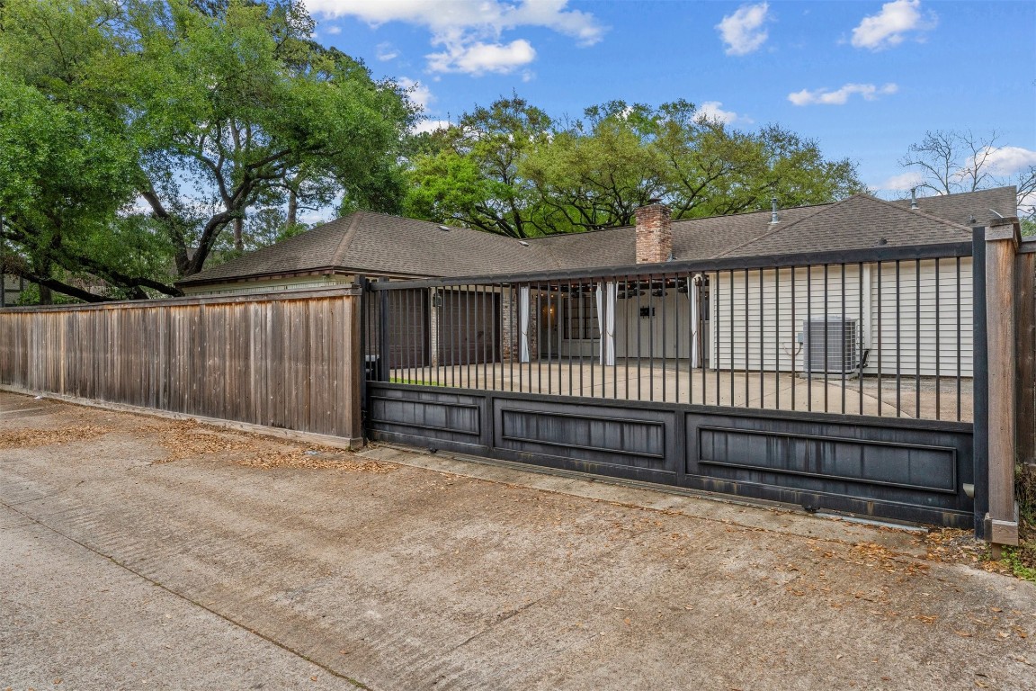 602 Aldersgate Court Katy, TX 77450 - Photo 13 of 24 a view of a house with a wooden fence and trees