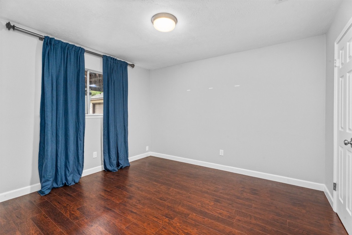 602 Aldersgate Court Katy, TX 77450 - Photo 18 of 24 a view of an empty room with wooden floor and a window