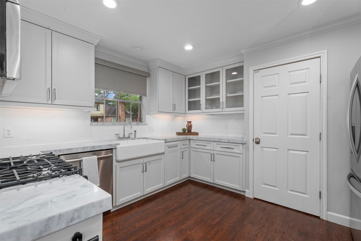 602 Aldersgate Court Katy, TX 77450 - Photo 4 of 24 a kitchen with a sink stove and cabinets