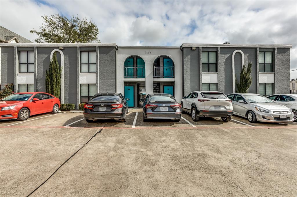a couple of cars parked in front of a building