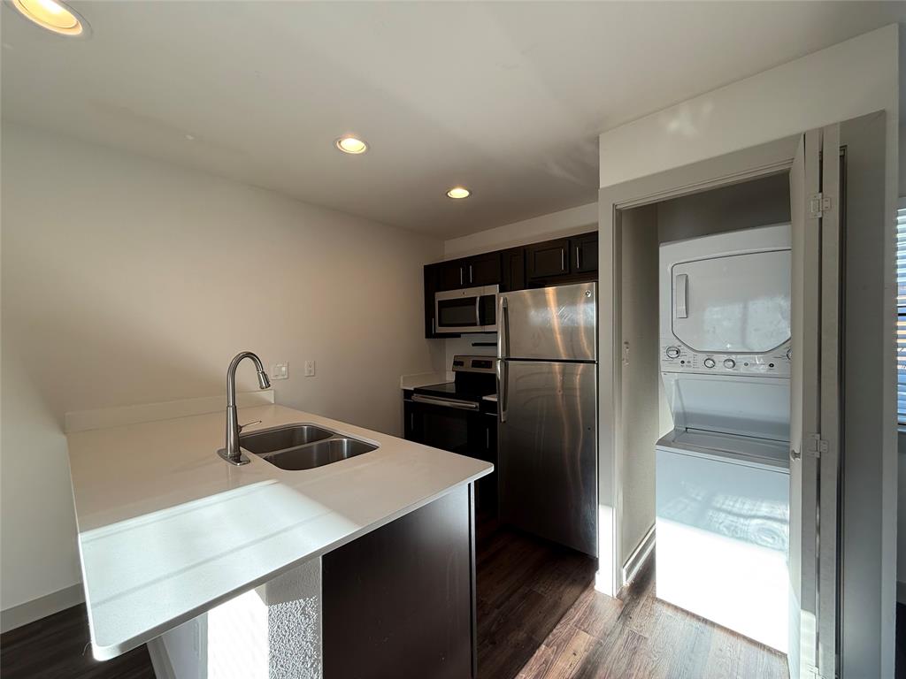2106 Bennett Avenue, Unit 106 Dallas, TX 75206 - Photo 11 of 14 a kitchen with kitchen island a counter top space cabinets and stainless steel appliances