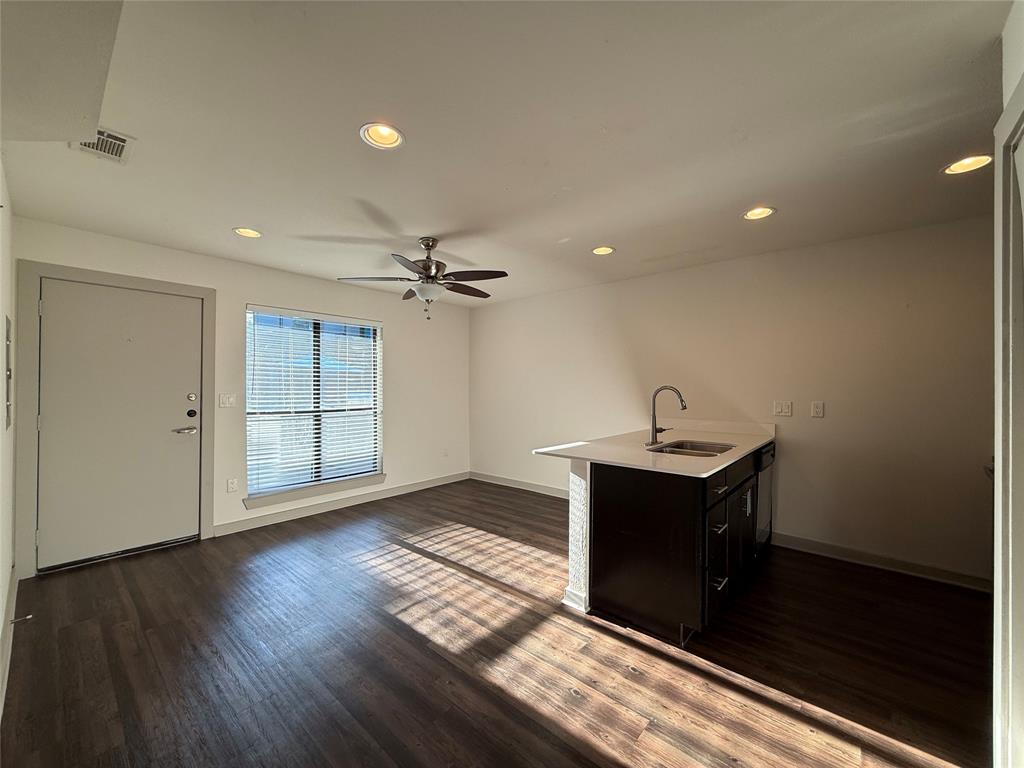 2106 Bennett Avenue, Unit 106 Dallas, TX 75206 - Photo 4 of 14 a view of a livingroom with wooden floor and a ceiling fan