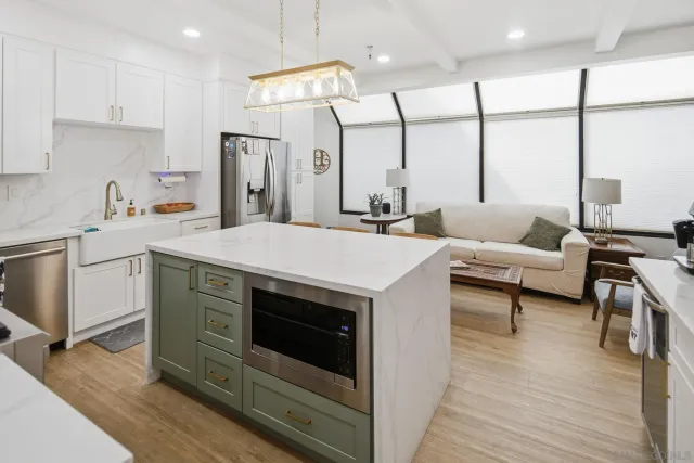 a bathroom with a double vanity sink a mirror a shower and a bathtub