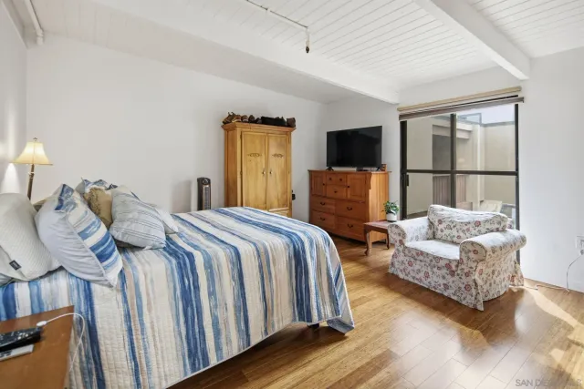 a view of a dining room with furniture a chandelier and wooden floor