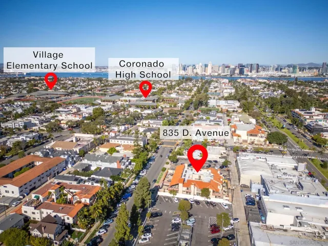 a kitchen with stainless steel appliances kitchen island granite countertop a refrigerator a stove a sink a dining table and chairs with wooden floor