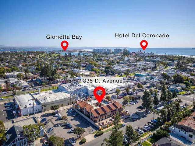 a kitchen with stainless steel appliances a stove a sink a microwave a refrigerator and white cabinets