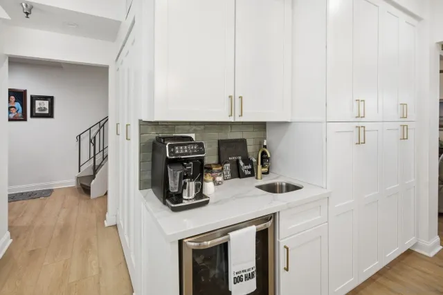a living room with furniture a refrigerator and a table