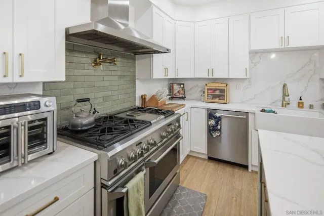 a kitchen with stainless steel appliances a refrigerator and cabinets
