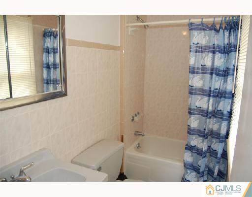 8 Tamarack Road Somerset, NJ 08873 - Photo 7 of 8 a bathroom with a bathtub and a shower