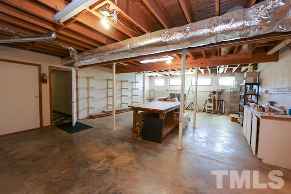 5712 Crutchfield Road Raleigh, NC 27606 - Photo 17 of 21 Amazing 47' x 23' workshop in basement with outside and inside entrance.