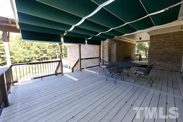 5712 Crutchfield Road Raleigh, NC 27606 - Photo 18 of 21 Recently refurbished deck with a retractable awning.