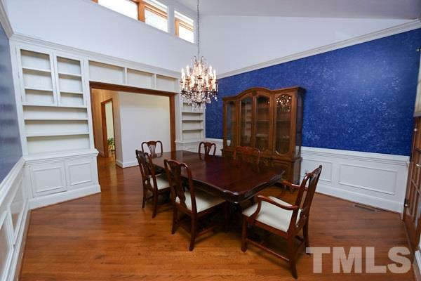 5712 Crutchfield Road Raleigh, NC 27606 - Photo 6 of 21 Formal dining room with vaulted ceiling, wainscoting and custom built ins