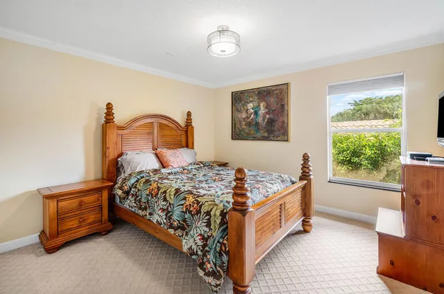 a bedroom with a large bed and a flat screen tv