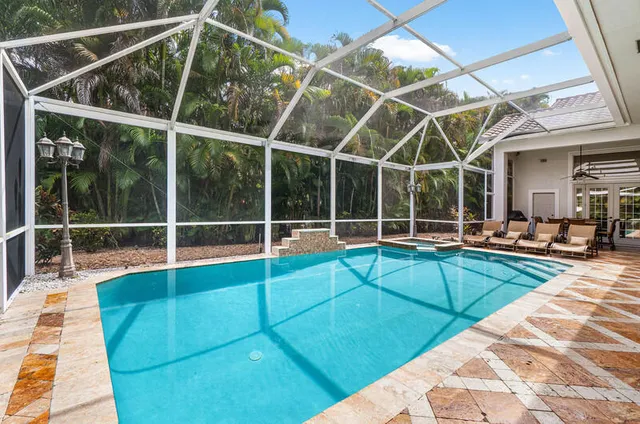 a view of a backyard with table and chairs and potted plants