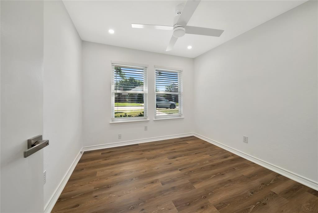 2909 Normandy Court Euless, TX 76039 - Photo 21 of 36 an empty room with wooden floor and windows