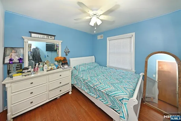 a bedroom with a bed and a dresser