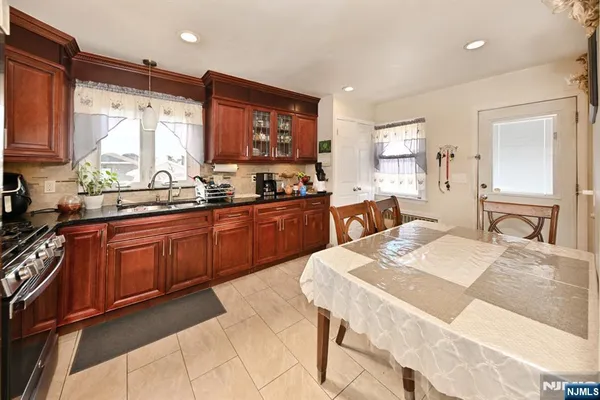 a large kitchen with kitchen island granite countertop a sink stove and refrigerator