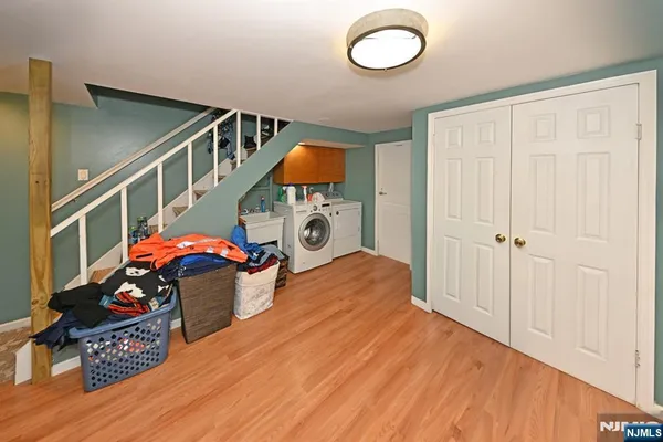 a view of a hallway to a livingroom with furniture and wooden floor