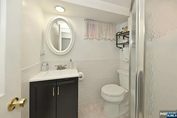 a bathroom with a toilet a sink and a mirror