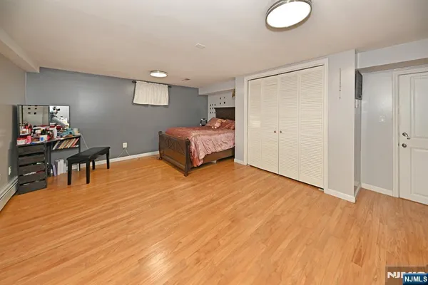 a spacious bedroom with a bed and a bookshelf