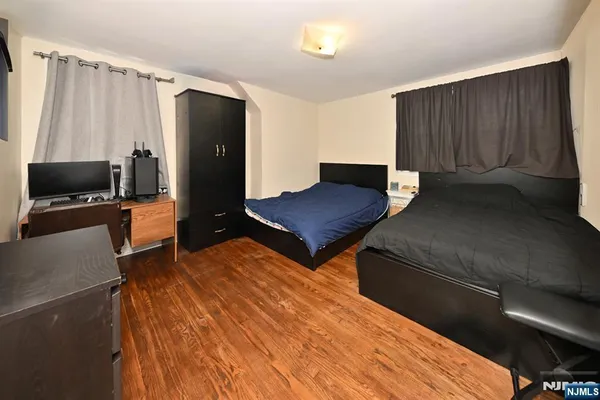 a living room with a bed furniture and a flat tv screen