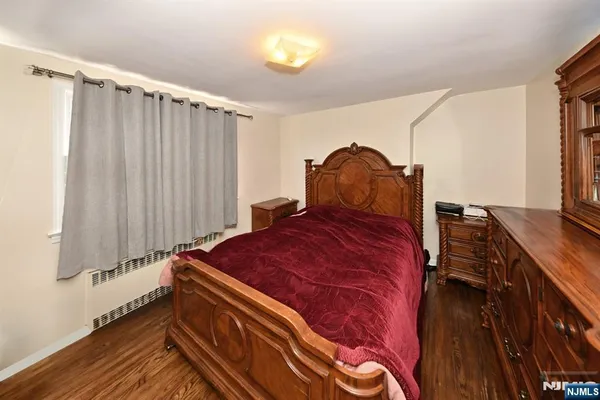 a bed sitting in a bedroom next to a window