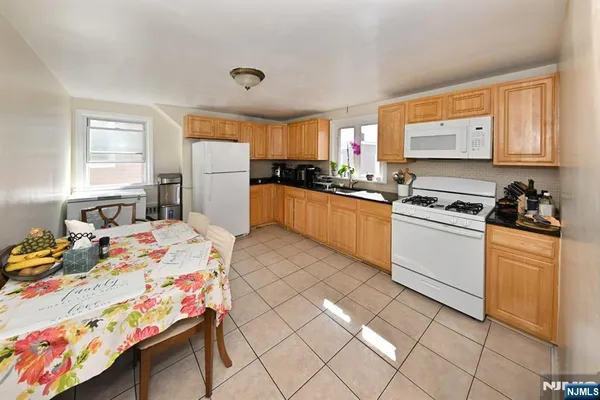 a kitchen with a sink appliances and cabinets