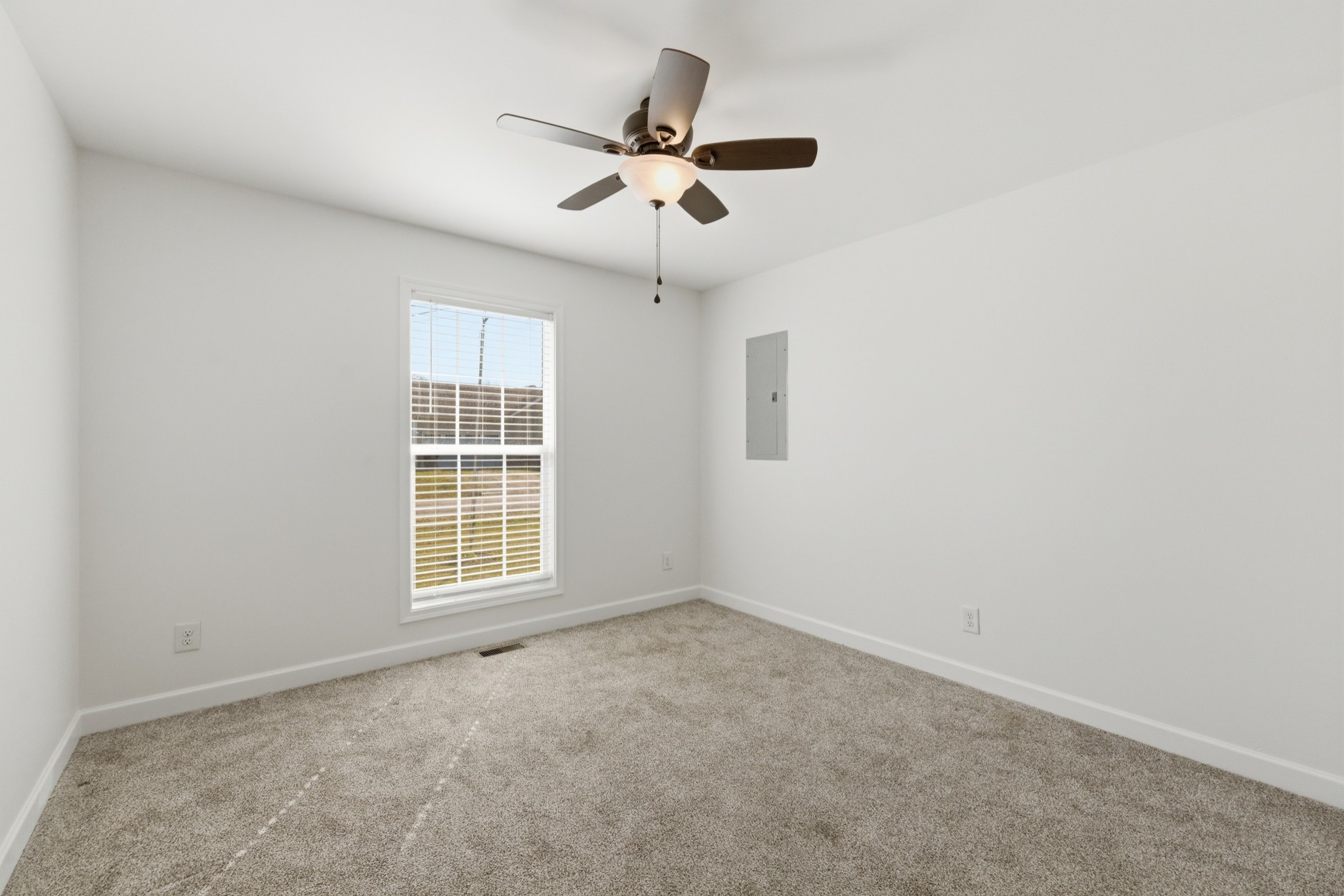 217 Spring Breeze Drive Smithville, TN 37166 - Photo 20 of 34 an empty room with windows and ceiling fan