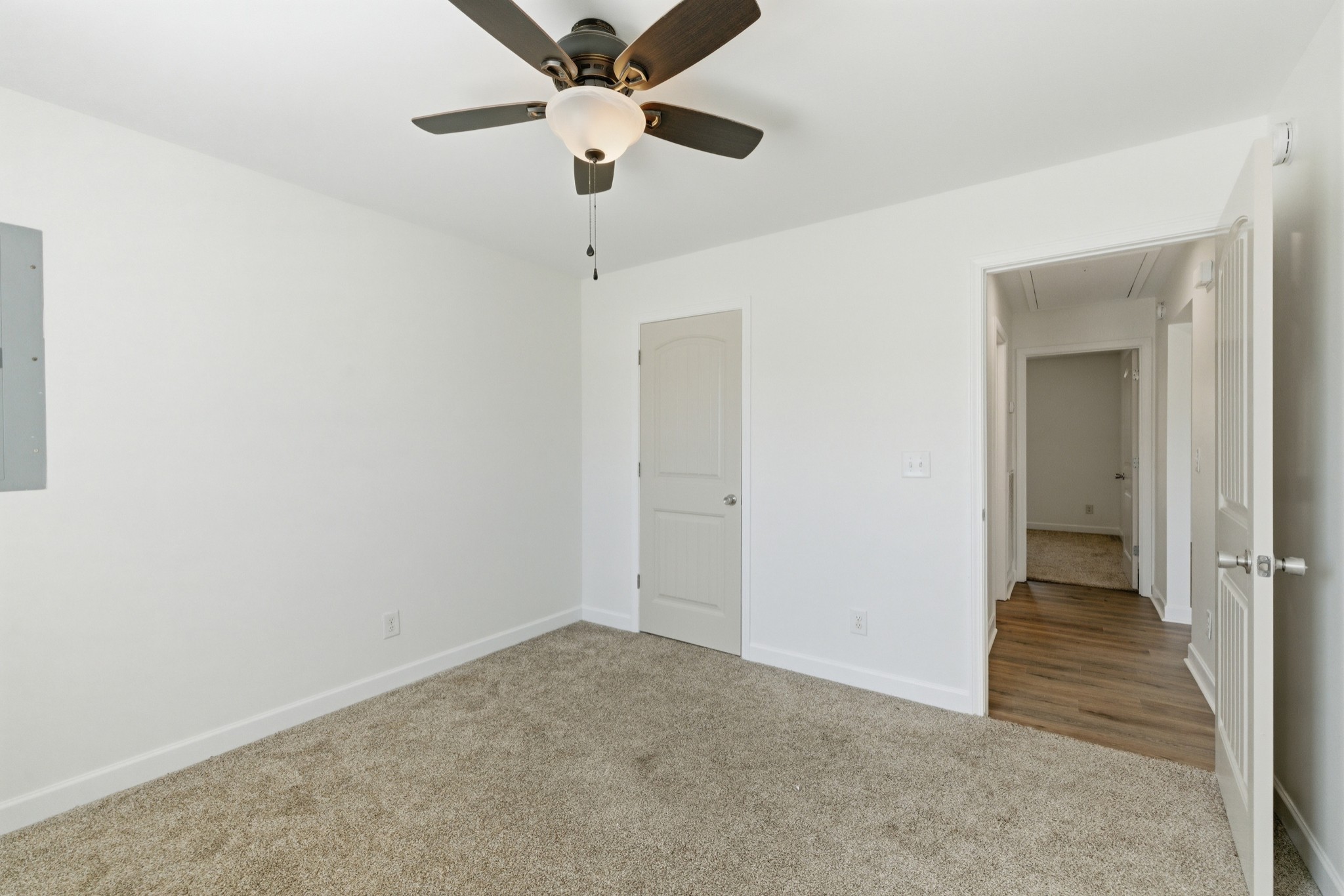 217 Spring Breeze Drive Smithville, TN 37166 - Photo 21 of 34 an empty room with a hallway and a chandelier fan
