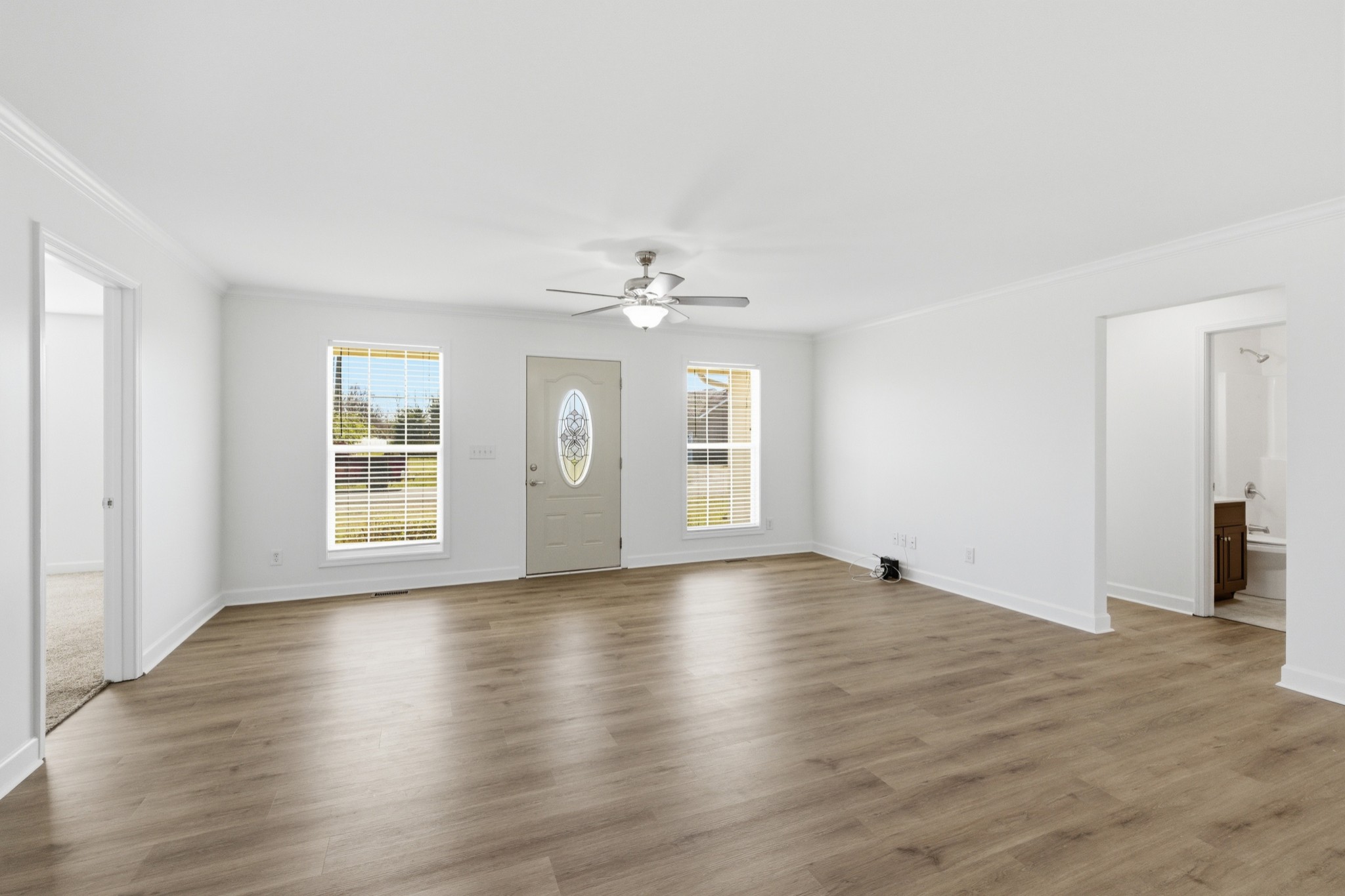 217 Spring Breeze Drive Smithville, TN 37166 - Photo 6 of 34 an empty room with wooden floor chandelier and windows