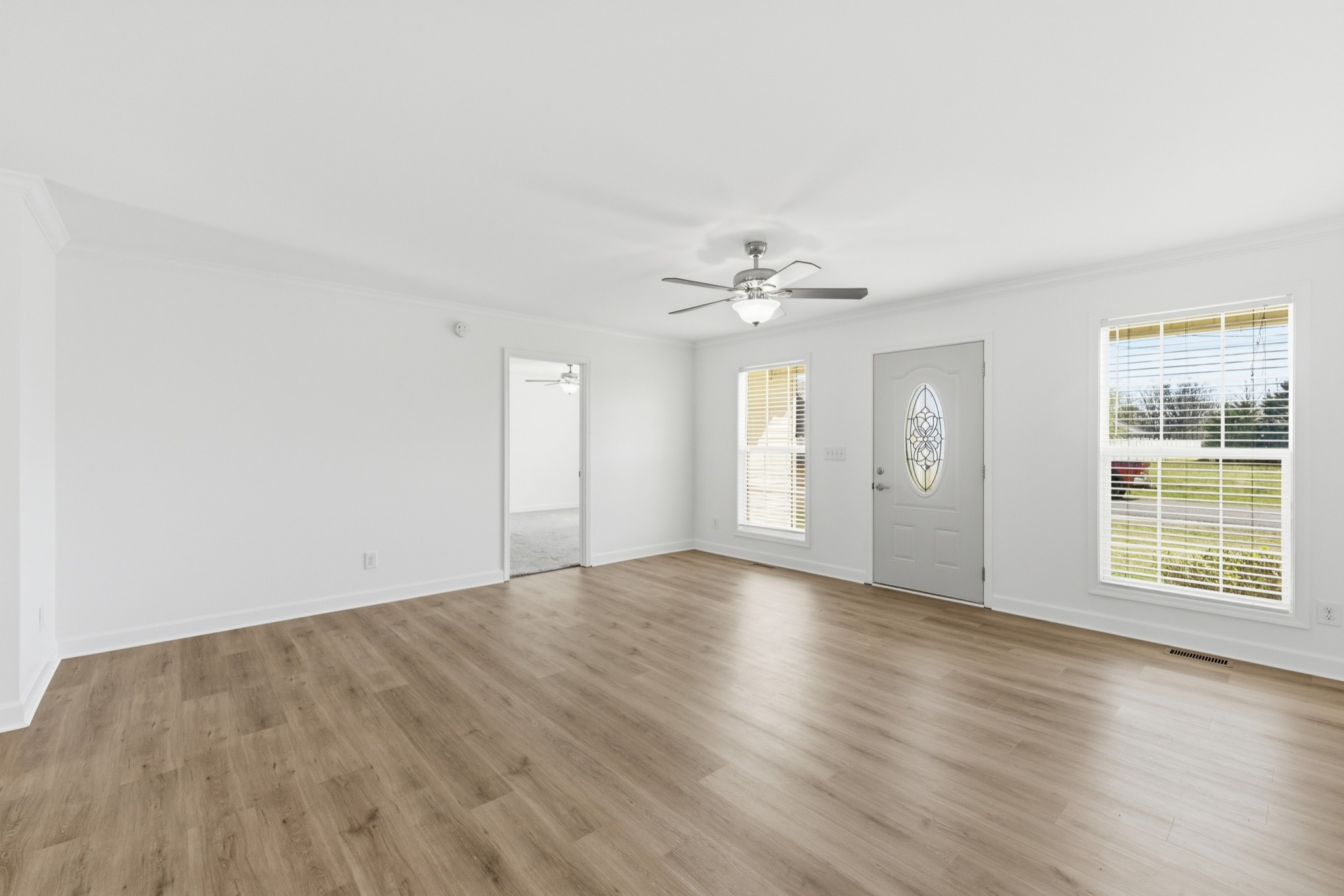 217 Spring Breeze Drive Smithville, TN 37166 - Photo 7 of 34 a view of an empty room with wooden floor and window