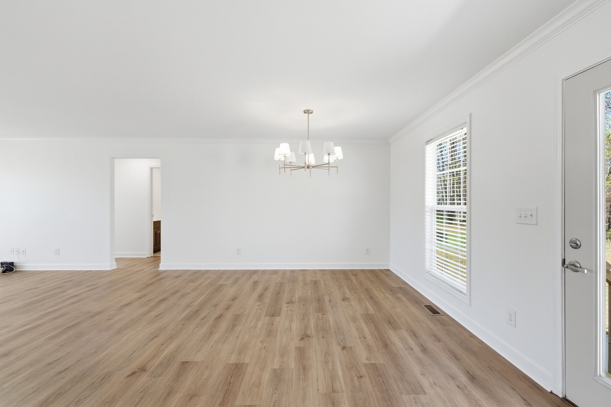 217 Spring Breeze Drive Smithville, TN 37166 - Photo 10 of 34 an empty room with wooden floor and windows