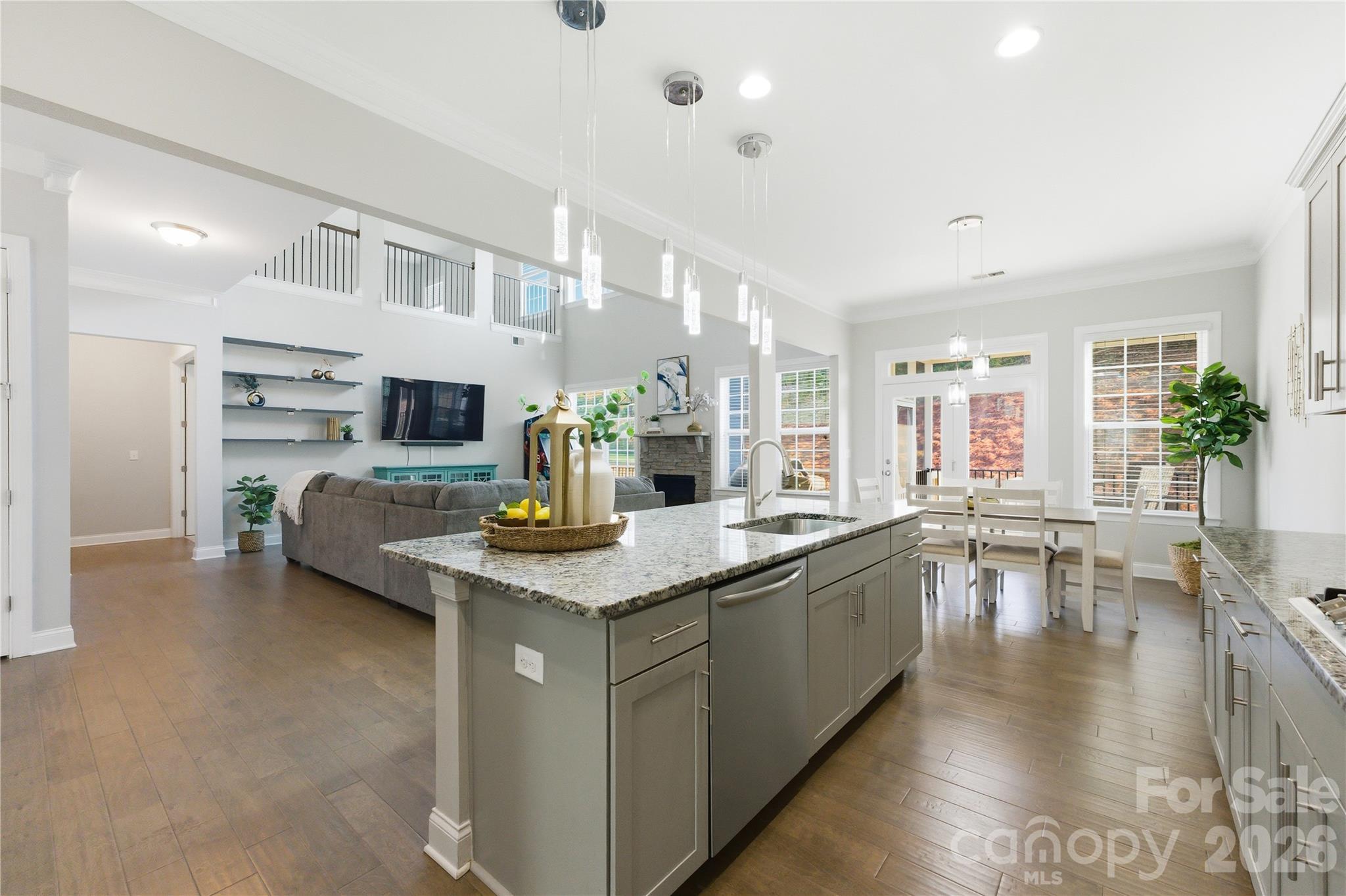 194 Forsythia Lane Tega Cay, SC 29708 - Photo 12 of 37 a kitchen with stainless steel appliances granite countertop a sink a stove top oven a dining table and chairs