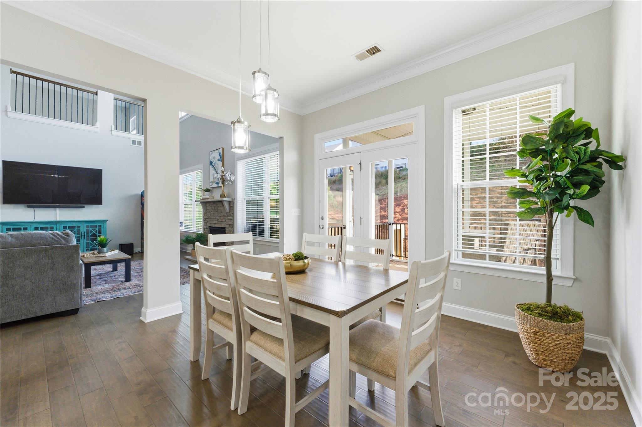 194 Forsythia Lane Tega Cay, SC 29708 - Photo 14 of 31 a dining room with furniture potted plants and wooden floor