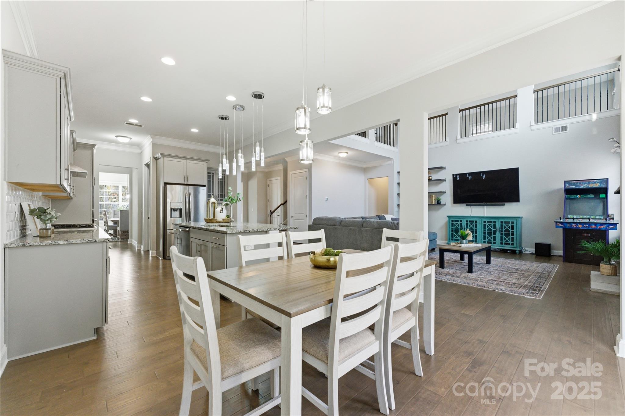194 Forsythia Lane Tega Cay, SC 29708 - Photo 15 of 31 a dining room with stainless steel appliances kitchen island granite countertop a table and chairs