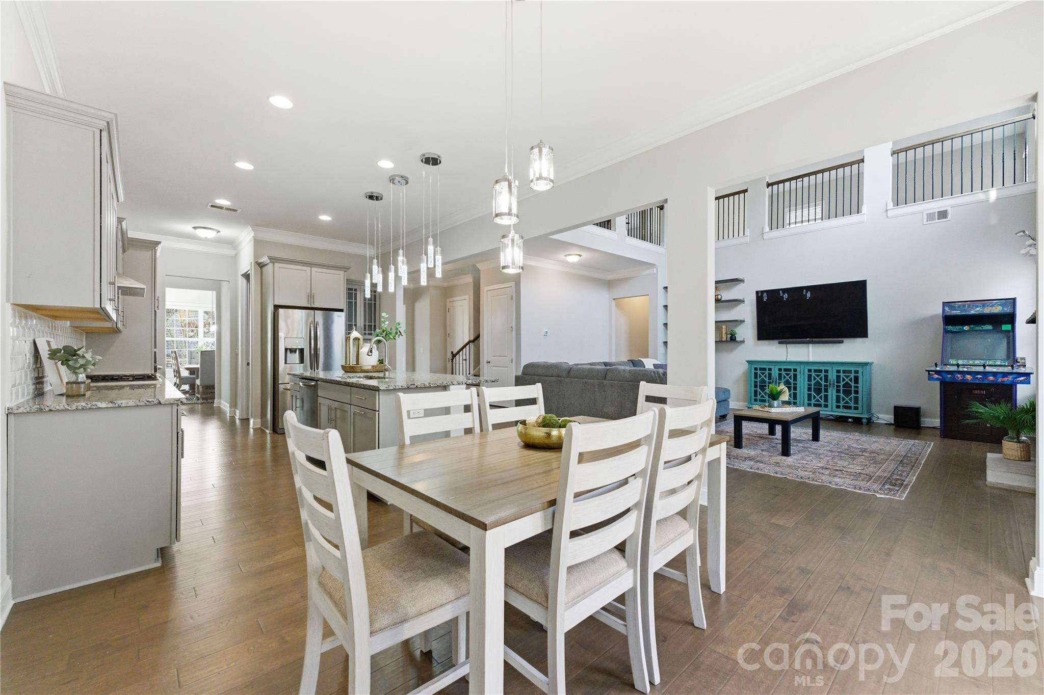194 Forsythia Lane Tega Cay, SC 29708 - Photo 15 of 36 a dining room with stainless steel appliances kitchen island granite countertop a table and chairs