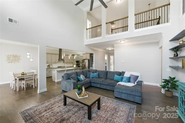 a living room with furniture and view of kitchen